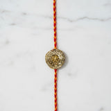 Golden lotus gota rakhi on marble - Divine Sansar