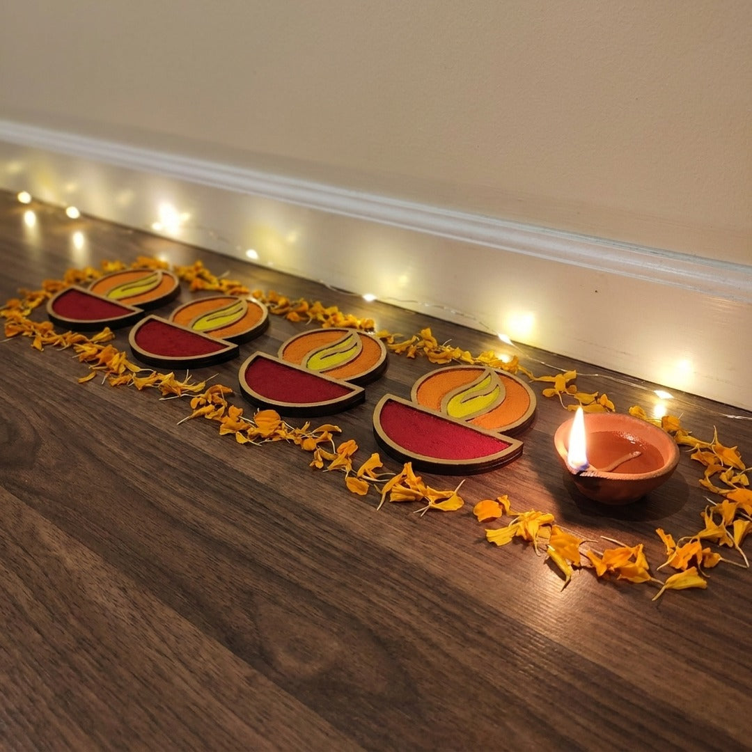 Set of 4 Diya 4 inch golden rangoli pieces laid along the wall in a Dubai home for Diwali - Divine Sansar