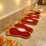 Set of 4 Laxmi Charan 4 inch golden rangoli pieces laid along the wall in a Dubai home for Diwali - Divine Sansar