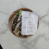 Havan kit packed inside its terracotta clay vedi with the havan vidhi card on top - Divine Sansar