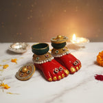 Laxmi Charan terracotta footprints on a Lakshmi Pujan altar with marigold petals and diyas, Divine Sansar