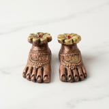 Close-up of the Laxmi Charan paduka pair with swastik, anklets and fixed gold flower - Divine Sansar