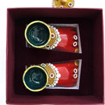 Laxmi Charan pair seated in the maroon velvet lined gift box tray, Divine Sansar
