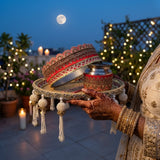 Majestic Glow red and gold Karwa Chauth thali held at moonrise on a rooftop for the chhalni ritual - Divine Sansar