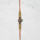 Mayura Tejas Gold Peacock Meenakari Rakhi on marble - Divine Sansar UAE
