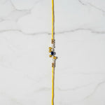 Moti Nazar Pearl Evil Eye Rakhi on marble - Divine Sansar UAE