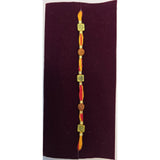 Om and rudraksha thread rakhi close up Divine Sansar