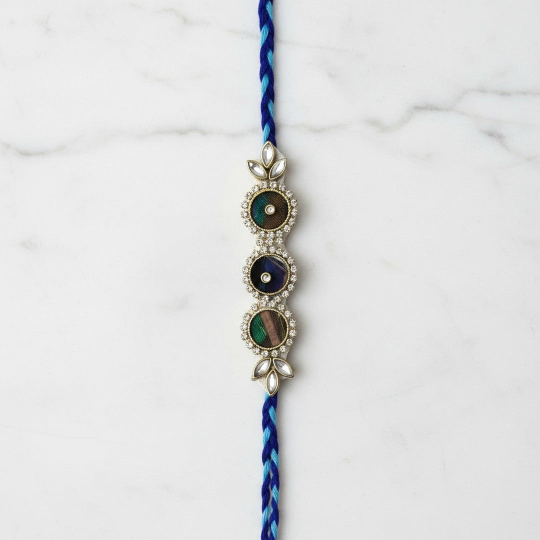 Peacock feather Mor Pankh rakhi on marble - Divine Sansar