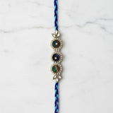 Peacock feather Mor Pankh rakhi on marble - Divine Sansar