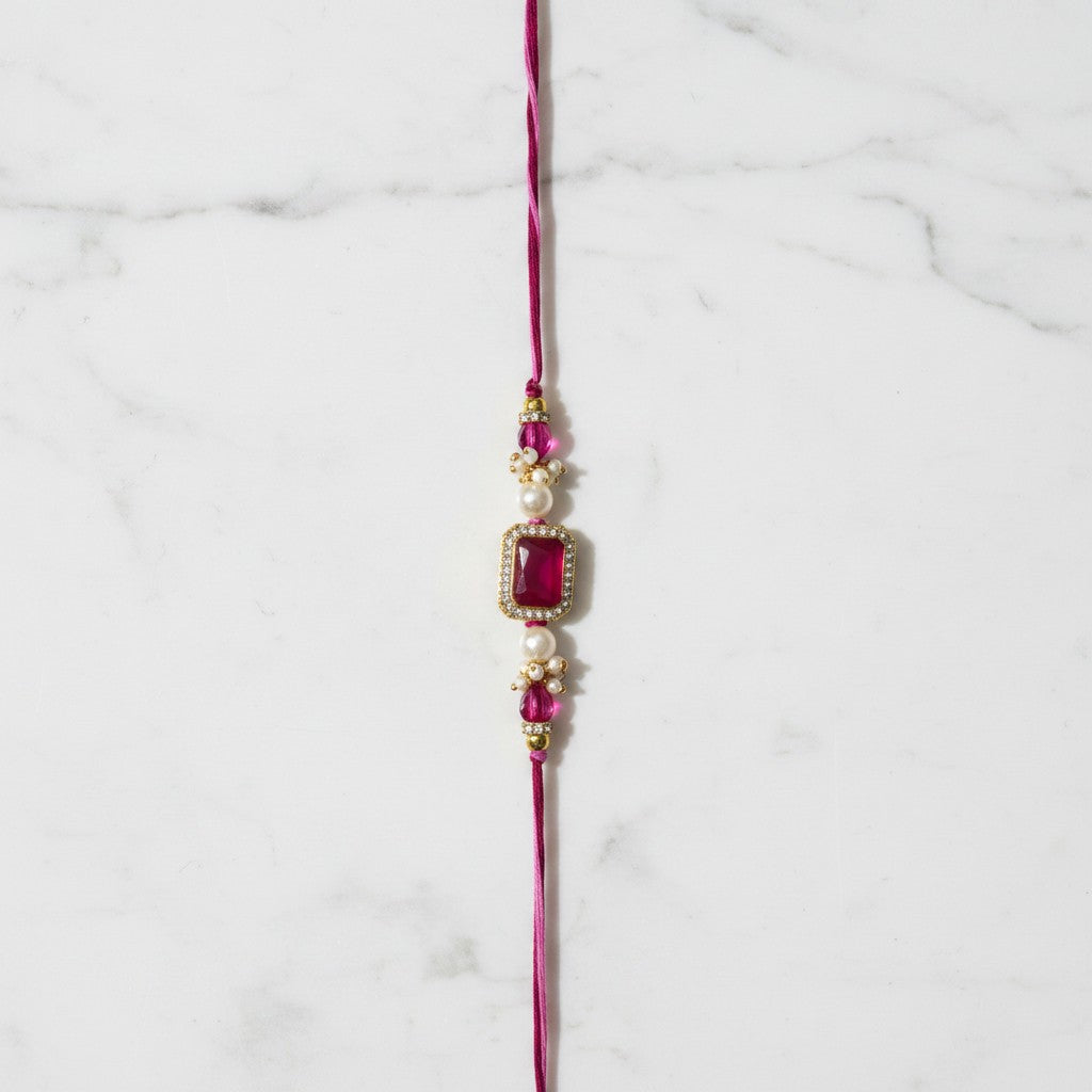 Gulabi Noor Pink Stone Rakhi on marble - Divine Sansar UAE