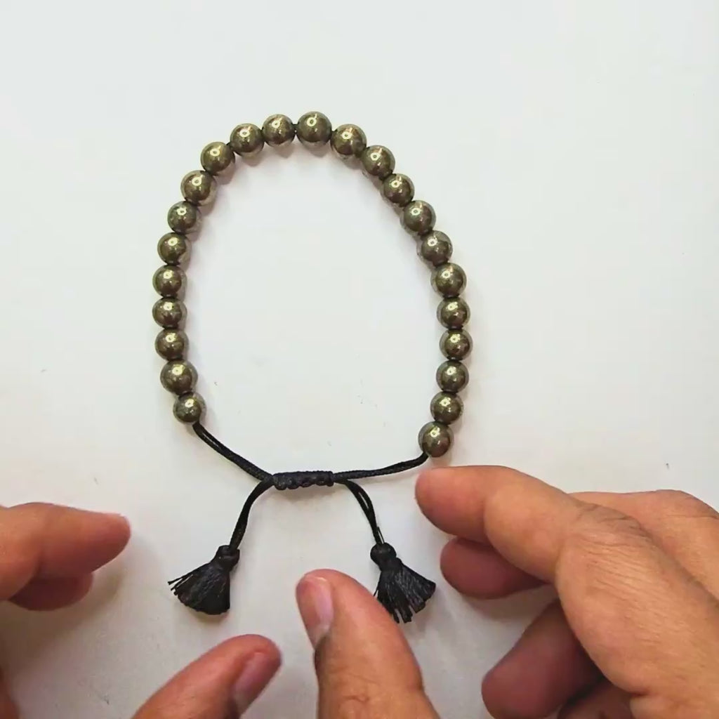 Video of the Braided Fit pyrite bracelet being adjusted by pulling the sliding knot cords - Divine Sansar