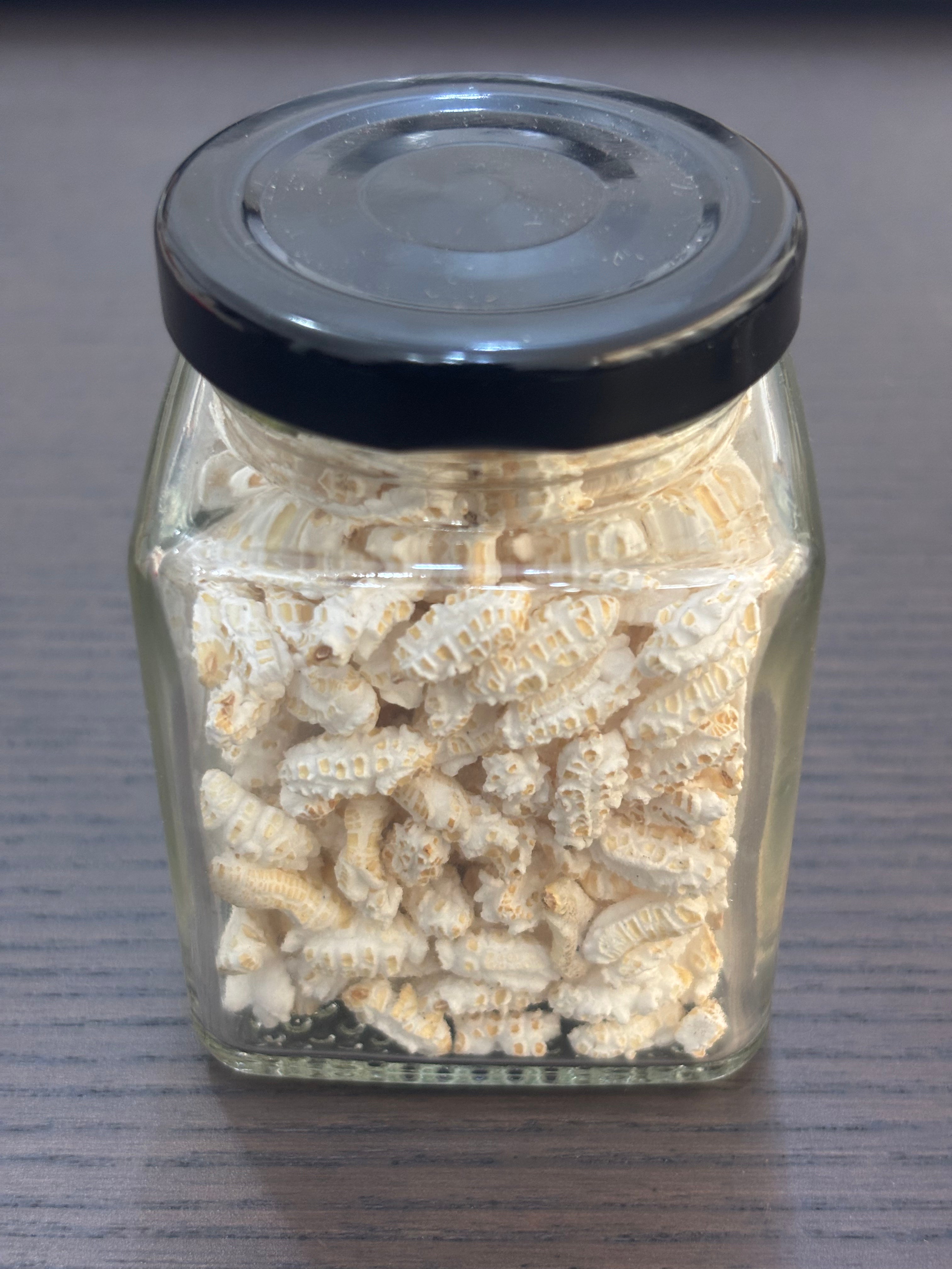 Divine Sansar-a square glass jar filled with puffed paddy