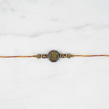 Two-sided pyrite prosperity rakhi on marble - Divine Sansar