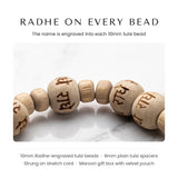 Close-up of Radhe engraving on 10mm tulsi (tulasi) beads of the Radhe Tulsi Bracelet - Divine Sansar