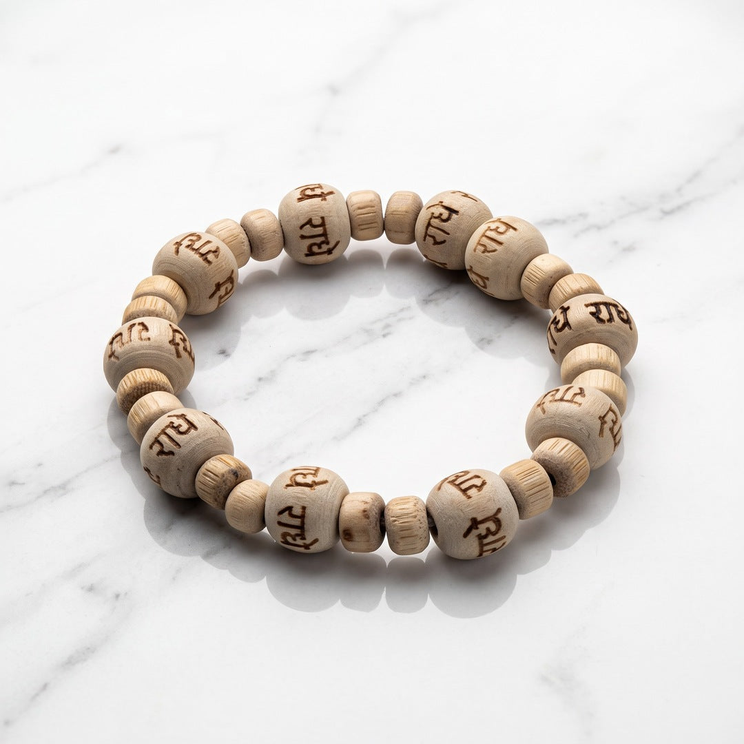 Natural tulsi (thulasi) wood bracelet engraved with Radhe on white marble - Divine Sansar