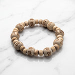 Natural tulsi (thulasi) wood bracelet engraved with Radhe on white marble - Divine Sansar
