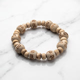 Natural tulsi (thulasi) wood bracelet engraved with Radhe on white marble - Divine Sansar