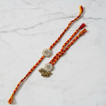 Gold zardozi pearl rakhi lumba set on marble - Divine Sansar