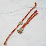 Gold zardozi pearl rakhi lumba set on marble - Divine Sansar