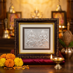 Silver Lakshmi Ganesh frame in pooja setup with diya - Divine Sansar