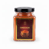 Hanuman Sindoor 100gm glass jar with black lid and maroon label - Divine Sansar