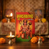 Sundarkand book on wooden puja altar with diya and marigold - Divine Sansar