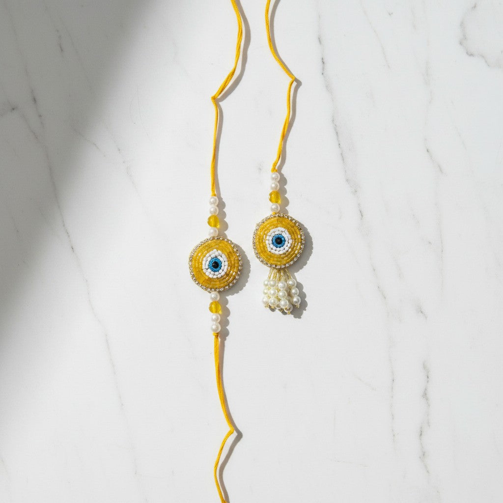 Drishti Jodi Sunehri Golden Evil Eye Bhaiya Bhabhi Rakhi Set on marble - Divine Sansar UAE
