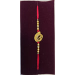 Gold peacock rakhi with tassel close up Divine Sansar