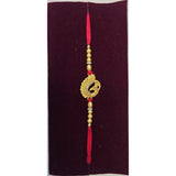 Gold peacock rakhi with tassel close up Divine Sansar