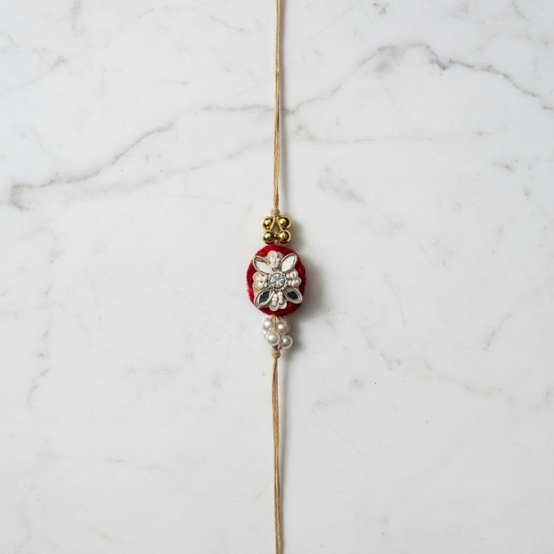 Velvet rose mirror and pearl rakhi on marble - Divine Sansar
