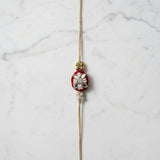 Velvet rose mirror and pearl rakhi on marble - Divine Sansar